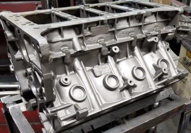 Engine block on a workshop table.